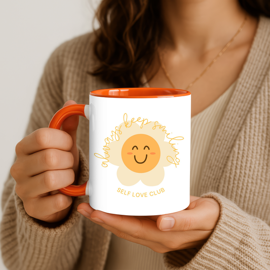 Person holding a mug with a smiling flower face design
