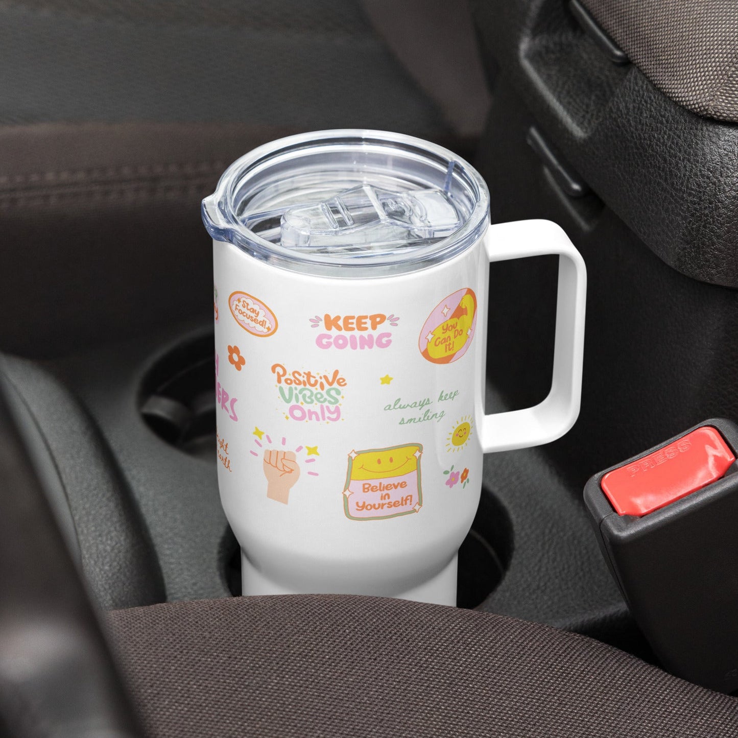 a white tumbler in a car cup holder