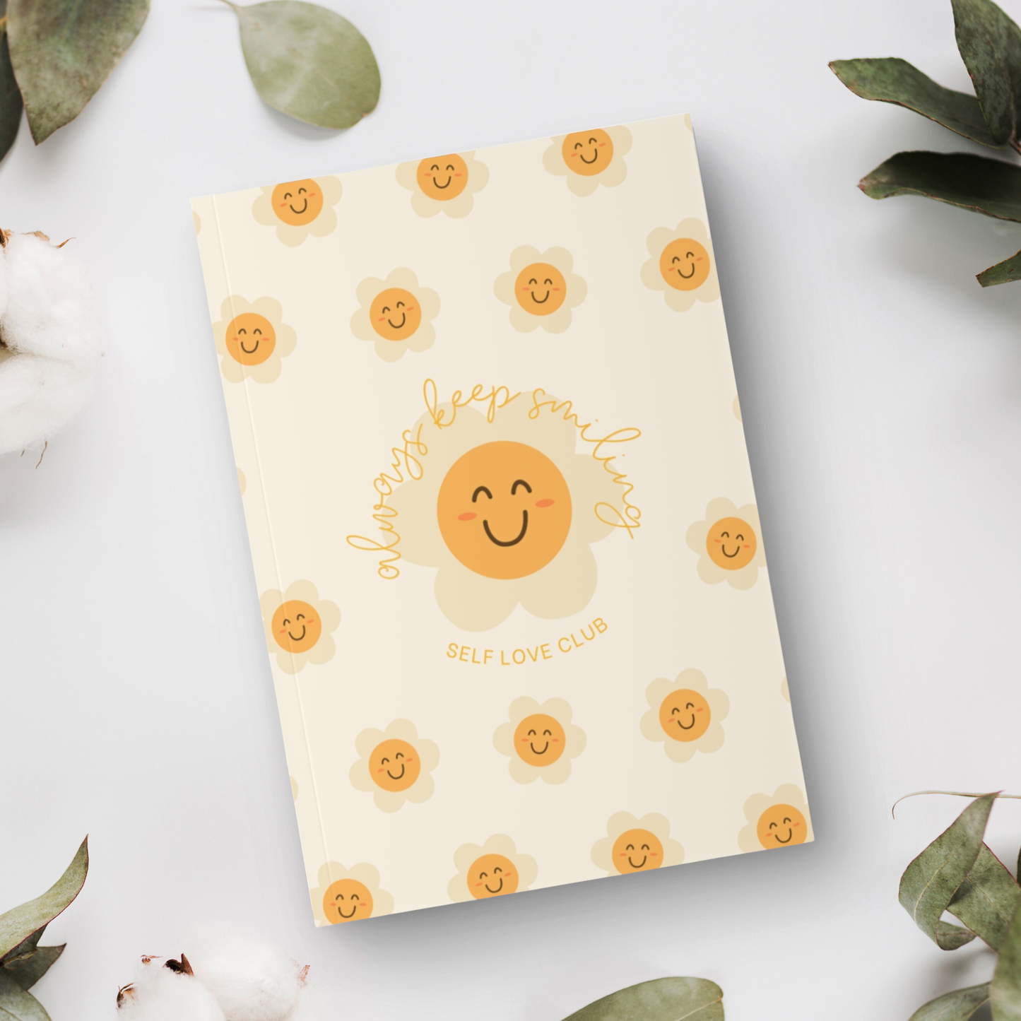 Notebook with flower and smiling face design on a light background