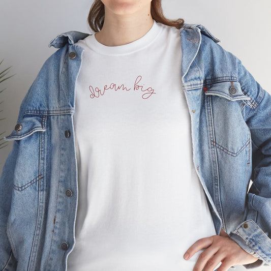 Person wearing a denim jacket over a white t-shirt with 'Dream big' text.