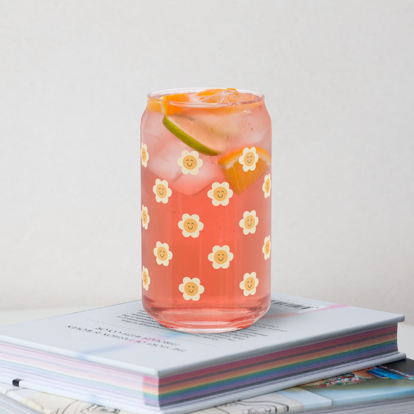 Floral-patterned glass with a drink on top of books