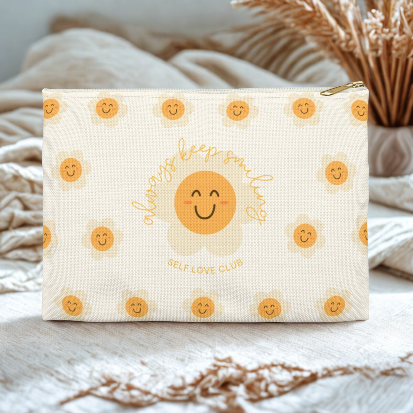 Cosmetic bag with smiling flower pattern and 'Self Love Club' text on a neutral background