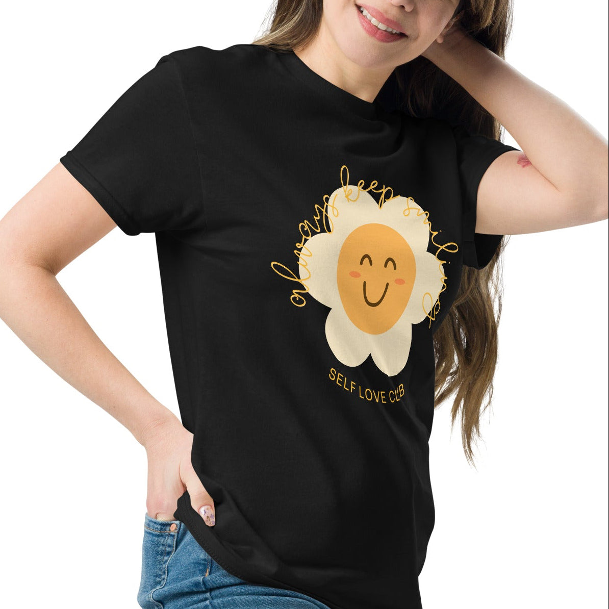 woman wearing a black tshirt with a happy flower graphic