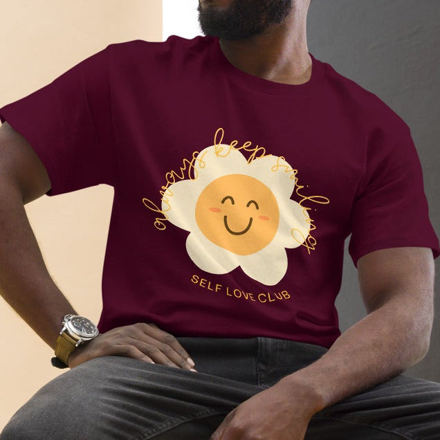 man wearing a maroon red tshirt with a happy flower graphic