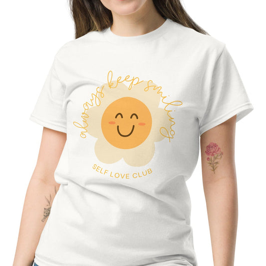 a woman wearing a white tshirt with a happy flower graphic