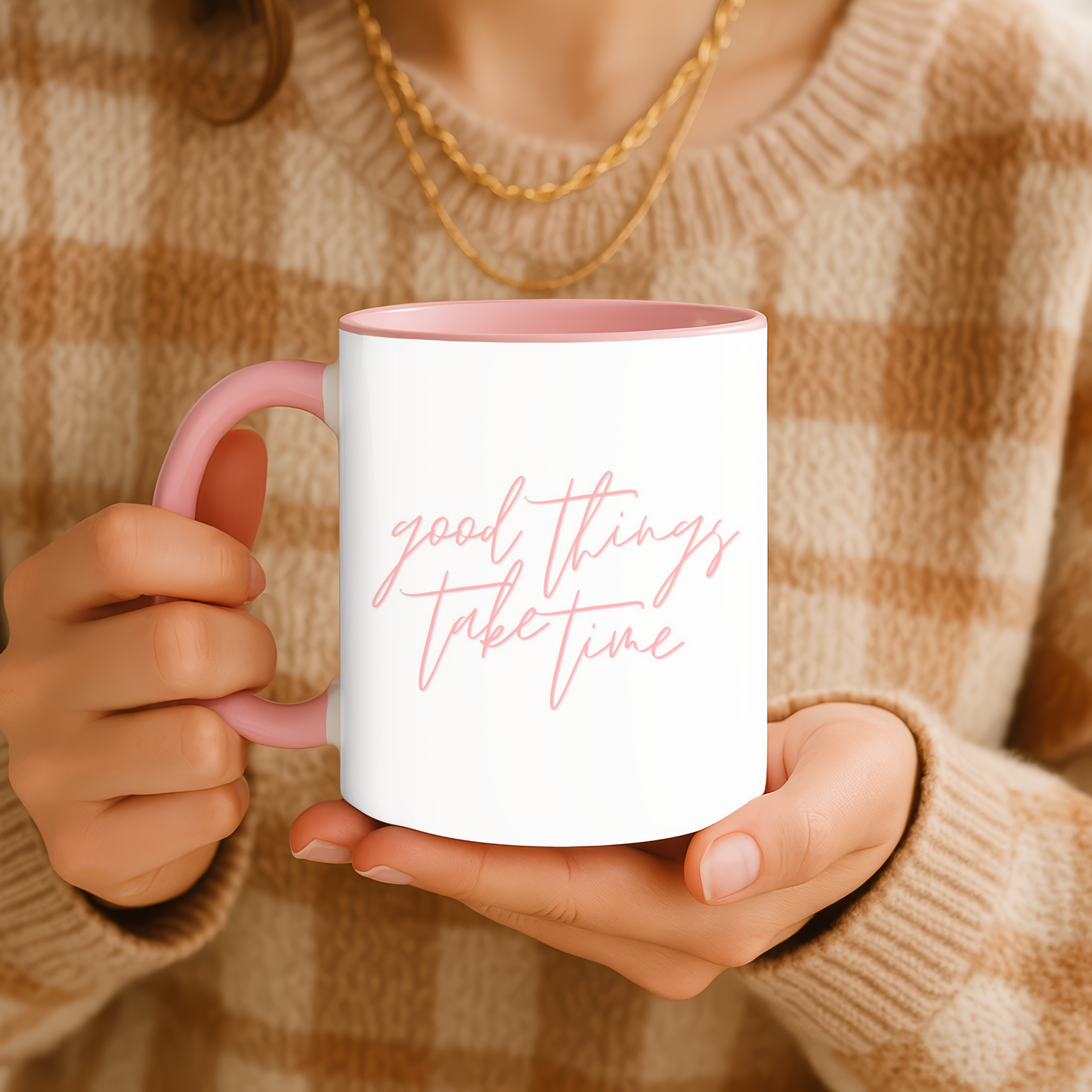 Person holding a mug with 'good things take time' text in a warm-toned setting