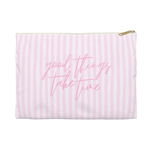 Pink striped pouch with 'good things take time' text on a white background