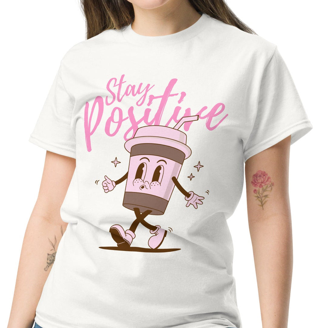 woman wearing white tshirt with a pink stay positive quote and coffee character